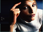 Picture of a young teen girl pointing to her head.